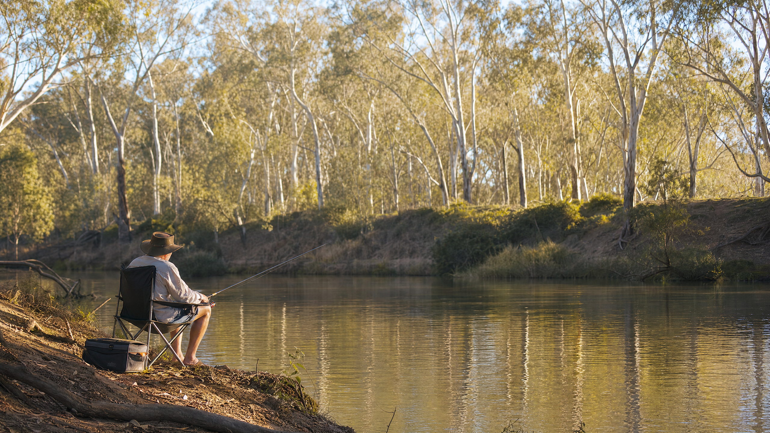 Angler fishing on an Australian river at sunset